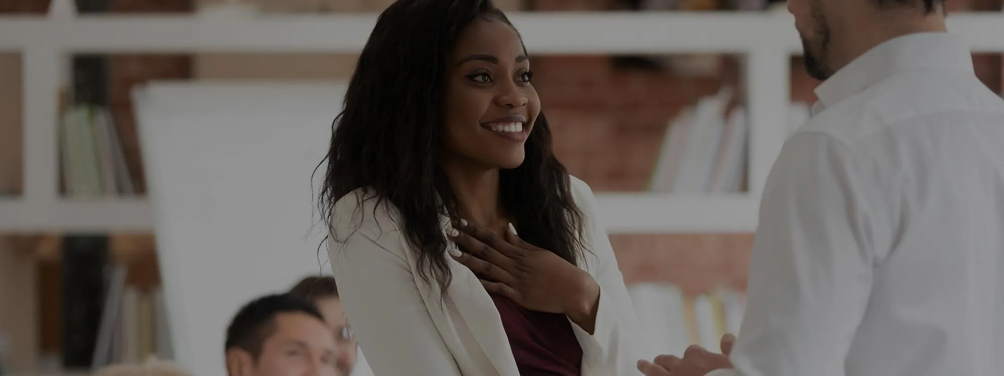 A photo of a woman shaking hands with a man.